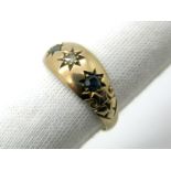 A 9ct Gold Sapphire and Diamond Three Stone Ring, of gypsy style star set.