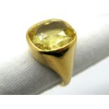 A Gent's Single Stone Ring, collet rubover set, between high plain tapering shoulders.