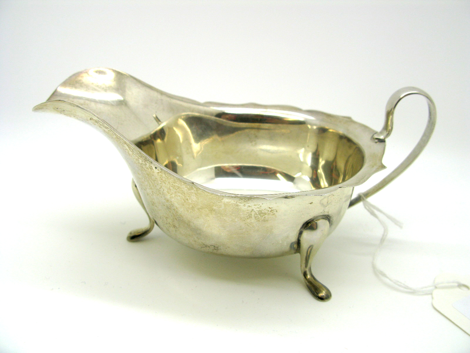 A Hallmarked Silver Sauce Boat, EV, Sheffield 1940, with wavy cut edge and loop handle raised on