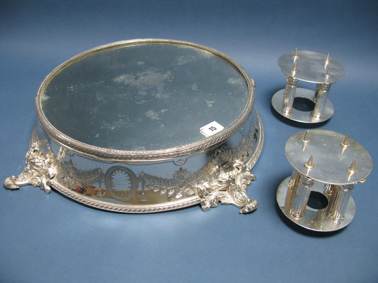 A Late XIX / Early XX Century Plated Wedding Cake Stand, with mirrored plateau, within a ribbon tied