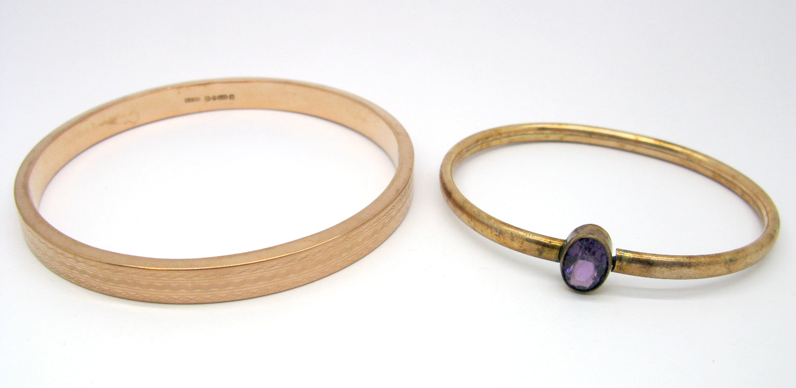 A 9ct Gold Upper Arm Bangle, engine turned, Chester 1924; together with another bangle, oval