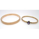 A 9ct Gold Upper Arm Bangle, engine turned, Chester 1924; together with another bangle, oval