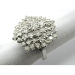 A Large 18ct White Gold Diamond Cluster Dress Ring, of shaped circular design, claw set throughout