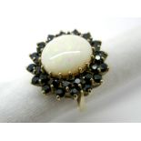 A Large 9ct Gold Opal and Sapphire Cluster Ring, oval cabochon claw set to the centre, within two