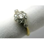 A Diamond Set Cluster Ring, of flowerhead design, graduated collet rubover set, between diamond