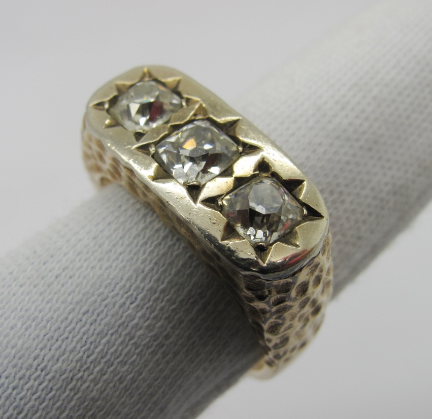 A Gent's Three Stone Diamond Ring, star rubover set to the top with three old cushion cut stones