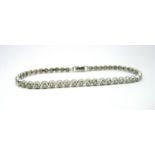 A Modern 18ct White Gold Diamond Set Line Bracelet, of uniform design, illusion claw set