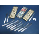 Two Boxed Sets of Six Mother of Pearl Handled Dessert Knives, with hallmarked silver ferrules