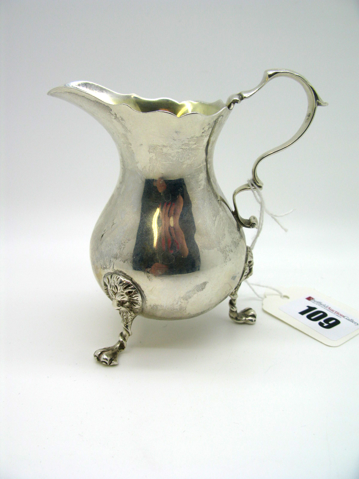 A Hallmarked Silver Cream Jug, Charles Stuart Harris, London 1901, of plain baluster form, raised on