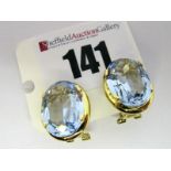 A Pair of Large Single Stone Earrings, each oval four claw set, on Continental hinged back fittings,