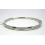 A Modern 18ct White Gold Princess Cut Diamond Set Bangle, channel set with uniform stones, hinged to