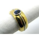 A Gent's Single Stone Sapphire Set Ring, the two tone band oval collet rubover set to the centre,