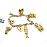 A 9ct Gold Curb Link Bracelet, to 9ct gold heart shape padlock clasp, suspending assorted novelty