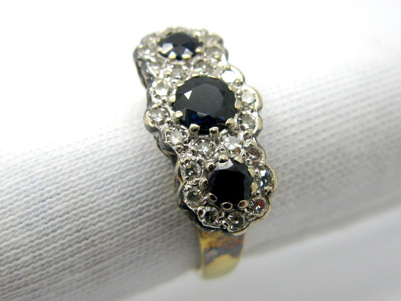 An 18ct Gold Sapphire and Diamond Set Triple Cluster Ring, graduated circular set within single