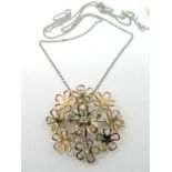 A Modern 18ct White and Rose Gold Designer Style Diamond Set Pendant, composed of articulated flower