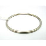 A Modern 9ct White Gold Bangle, of plain design, hinged to snap clasp.