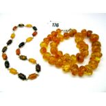 A Modern Amber Bead Necklace, of graduated design; Together with A Necklace, oval cabochon claw set.