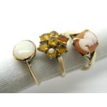 A 9ct Gold Cameo Ring, oval claw set between textured shoulders; a 9ct gold cluster dress ring and