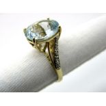 A 9ct Gold Single Stone Dress Ring, oval four claw set to the centre, high between textured inset