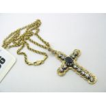 An Antique Style Cross Pendant, of shaped and textured design, claw set to the centre with an oval