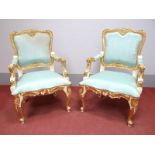 A Pair of XVIII Century French Style Gilt Wood Armchairs, with a shaped top rail, upholstered