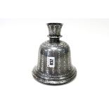 A Persian White Metal Candle Holder of Bell Form, with allover floral motifs and leaves, 16.5cm