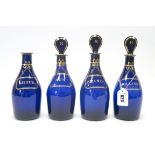 A Set of Four Early XIX Century 'Bristol' Blue Decanters, of mallet form, with three bulls eye
