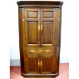 A Late XVIII Century Oak Double Corner Cupboard, with dentil cornice, panelled doors, central