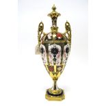 A Royal Crown Derby Porcelain Vase, of two-handled baluster form, with moulded cover, raised on a