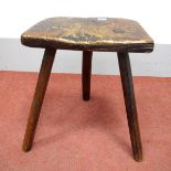 A XIX Century Elm Cutlers Stool, on splayed legs.