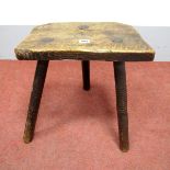 A XIX Century Elm Cutlers Stool, on splayed legs.