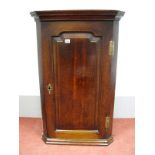 A XVIII Century Flat Fronted Oak Corner Wall Cupboard, having three shaped inner shelves, 98cm high,