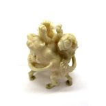 An Early XX Century Japanese Ivory Okimono, carved as three fighting lions, 5.5cm high.