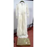 A Mid XX Century Vintage Cream Lace Wedding Dress, with fitted bodice and long fitted sleeves,