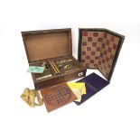 A Late XIX century Games Compendium, the plain mahogany rectangular box containing a chess set,