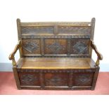 A Late XVII Century Oak Box Settle, with carved top rail, panelled back with lozenge carving, hinged