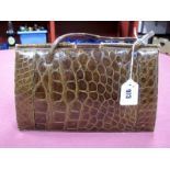 A Vintage Crocodile Skin Handbag, with gilt metal clasp and slim twin loop handles, suede lined;