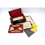 An Early XX Century Mah-Jong Set, with bone and bamboo pieces contained in four lift-out trays, with