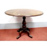 A XIX Century Mahogany Occasional Table, with snap-top action to oval top, on turned pedestal and