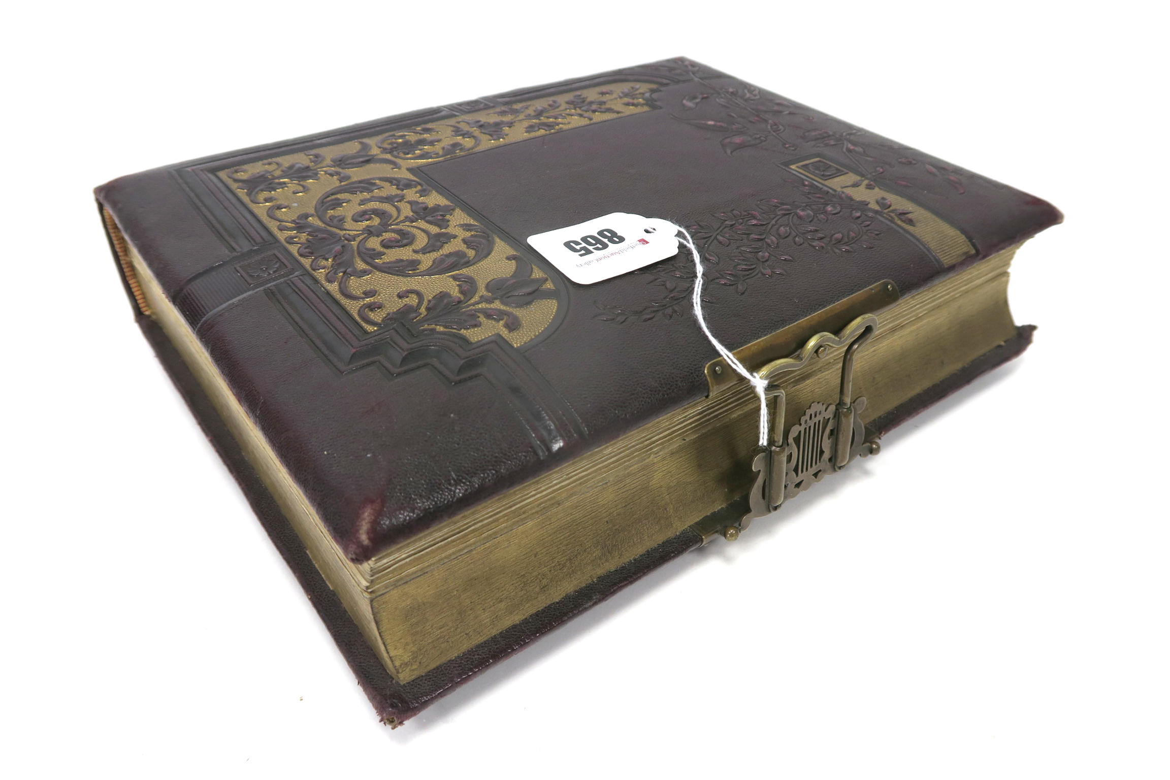 A Mid Victorian Tooled Leather Bound Musical Photograph Album, with brass clasp, the gilt edged