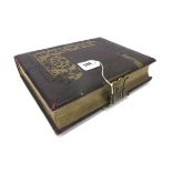 A Mid Victorian Tooled Leather Bound Musical Photograph Album, with brass clasp, the gilt edged