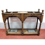 An Early XX Century Oak Umbrella Stand, with turned finials, four sectional top, carved frieze, on