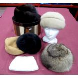 A Ladies Canadian Fox Fur Hat, two mink hats, two others and a Jane Shilton cream leather clutch