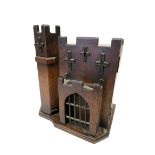 A Late XIX Century Oak Smoker's Cabinet, in the form of a castle, with pipe stand to the door,