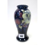 A Moorcroft Pottery Vase, of baluster form, painted in the 'Pansy' pattern against a dark blue