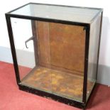 An Early XX Century Shop Display Unit, the painted metal surround with glazed panels and sliding