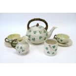 A Belleek Porcelain Part Bachelors Tea Service, in the Shamrock pattern against a moulded