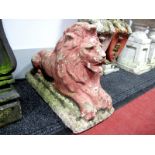 A Painted Composite Stone Recumbent Lion, upon a rectangular base, 67cm long.