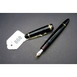 A Mont Blanc Meisterstuck 146 Fountain Pen, the black surfaces with gold coloured mounts, the gold