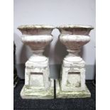 A Pair of Painted Composite Stone Garden Urns, of fluted campana form, each raised on tapered